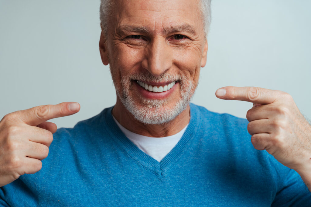 Handsome senior isolated on grey background.