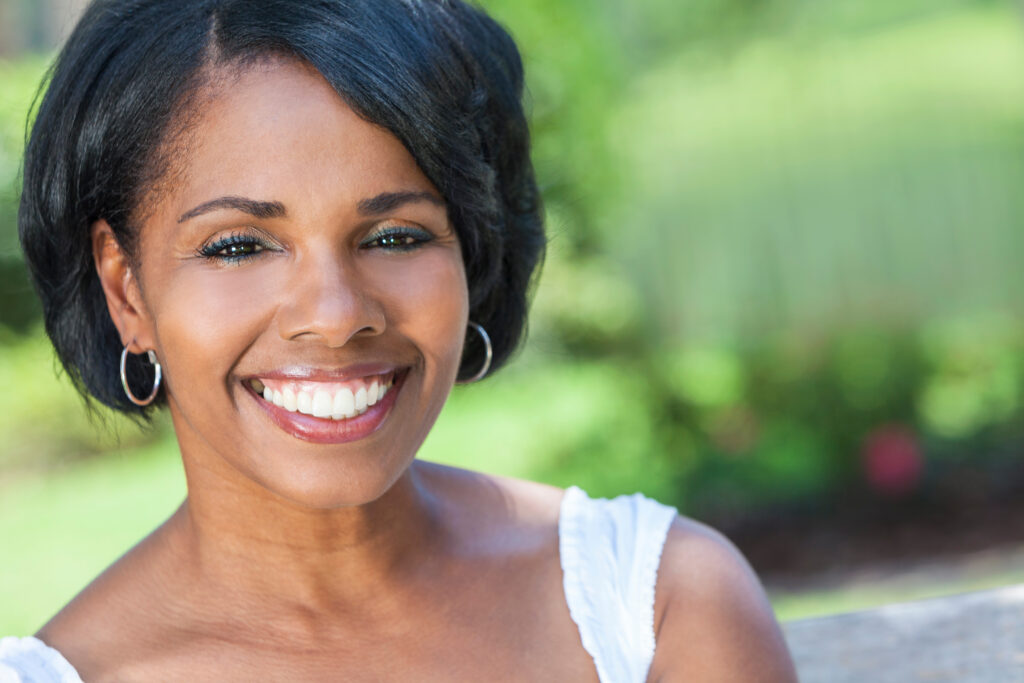 Beautiful African American woman smiling with perfectly straight, white teeth